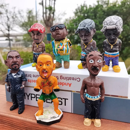 Orange resin statue of a hop rapper funny bro with green shorts and tattooed chest standing on a black base