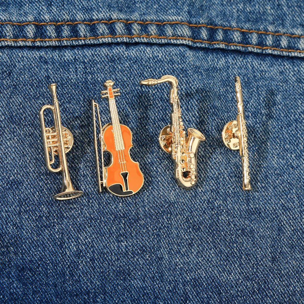 Set of four funny musical instruments enamel brooches shaped golden pins featuring trumpet violin saxophone and flute designs