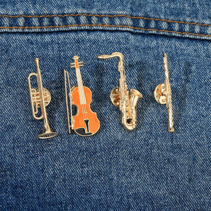 Set of four funny musical instruments enamel brooches shaped golden pins featuring trumpet violin saxophone and flute designs