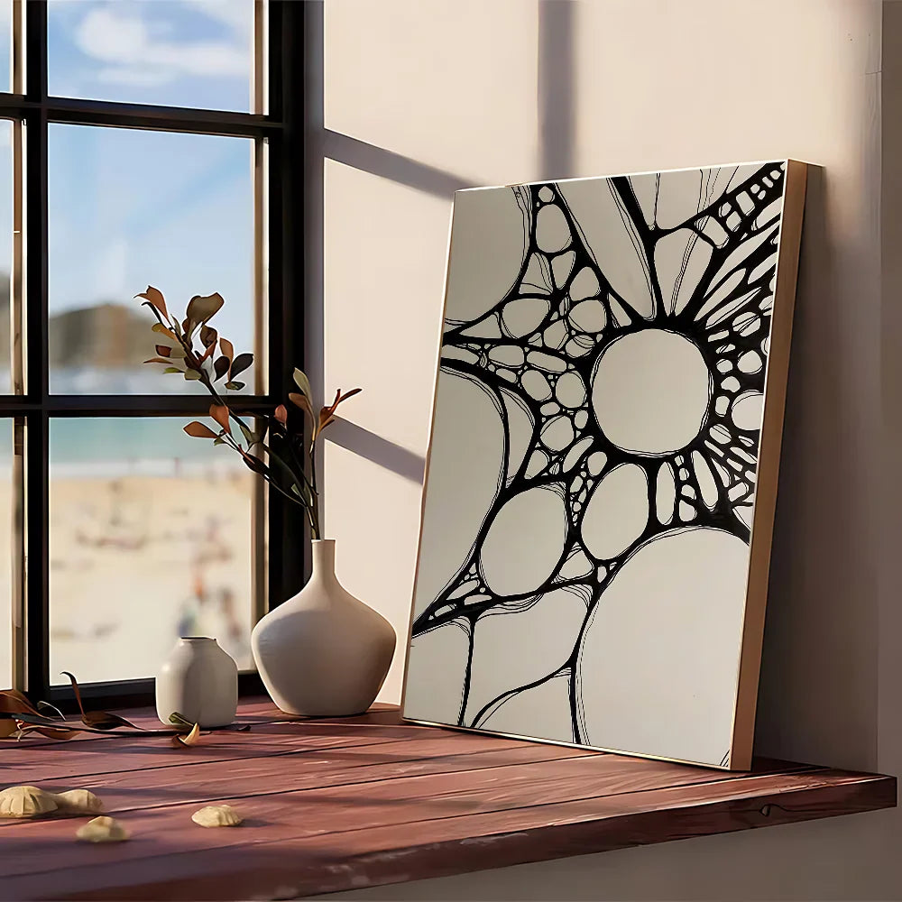 A modern graphic black and white geometric abstract painting framed in light wood on kraft club bar paper wall art