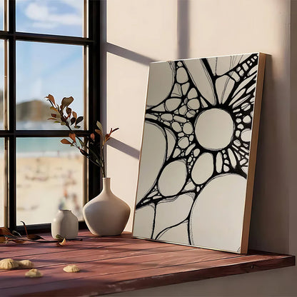 A modern graphic black and white geometric abstract painting framed in light wood on kraft club bar paper wall art
