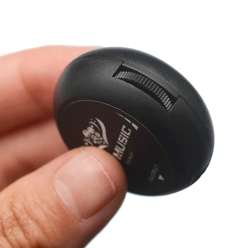 Black oval-shaped bluetooth speaker with textured surface and engraved music branding for guitar pickup piezo use