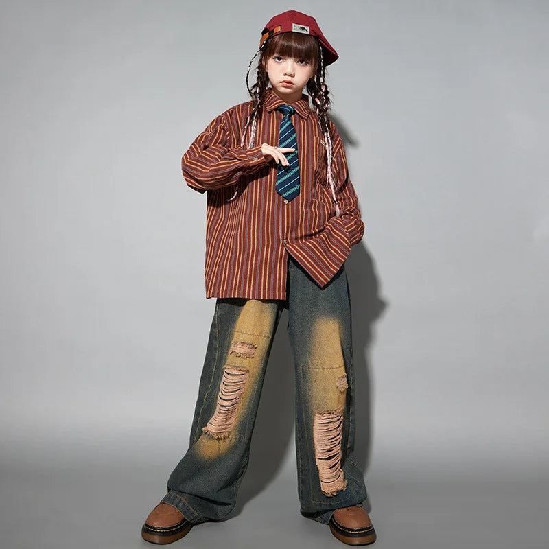 A young girl wearing a red beret girls hip hop set with striped shirt, blue tie, ripped jeans, and brown platform shoes