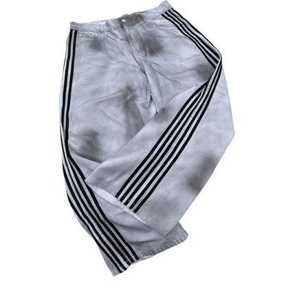 White track pants with black three stripe design and faded look complement gothic punk y2k hoodie two piece set