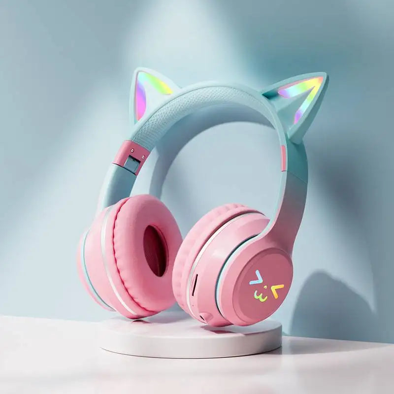 Pink gradient wireless headphones with cat ear bluetooth and microphone stereo music featuring rainbow led lights and cute face logo
