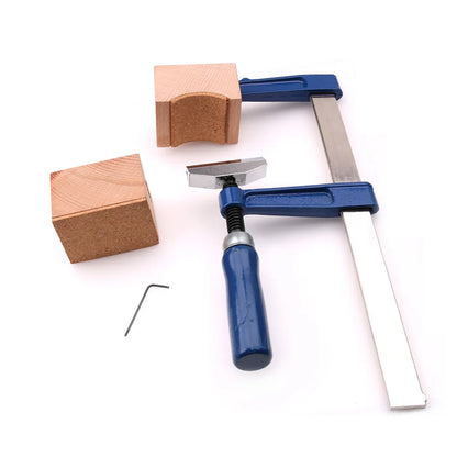 Blue-handled f clamp with metallic arms and silver adjustment head used as fret press tool with mini hexagonal wrench