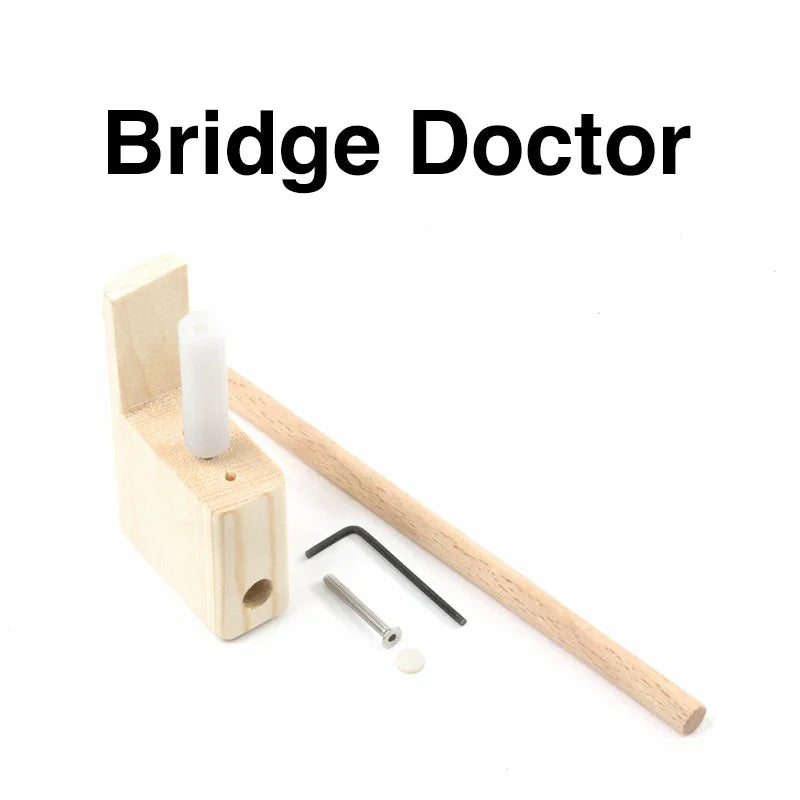 Light-colored wooden guitar bridge doctor with white cylindrical insert and metal hardware for musical instrument manufacturing