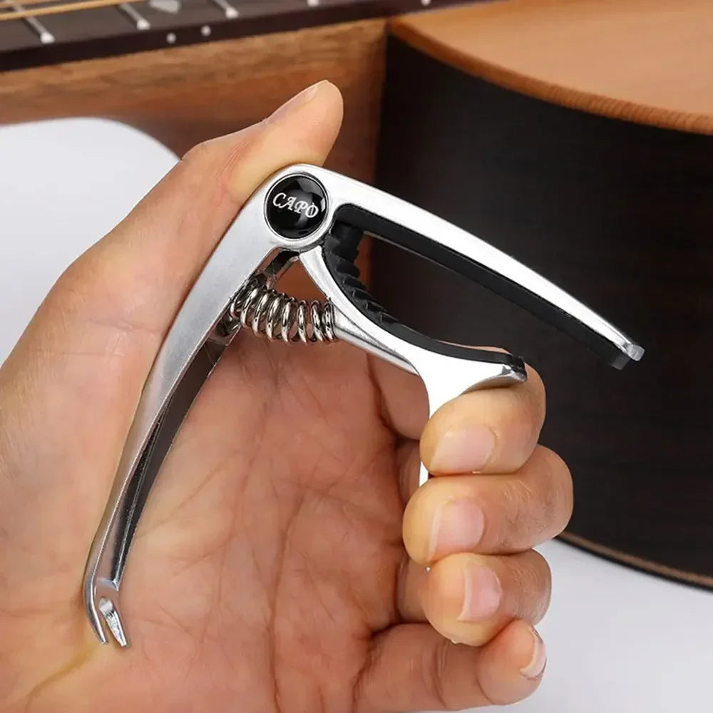 Silver guitar capo metal with black rubber grip and coiled spring alloy guitar tuner for acoustic electric musical instruments