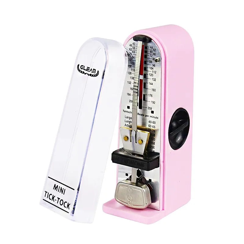 Pink plastic guitar mechanical metronome with clear cover and silver retro metronome pendulum for precise timing