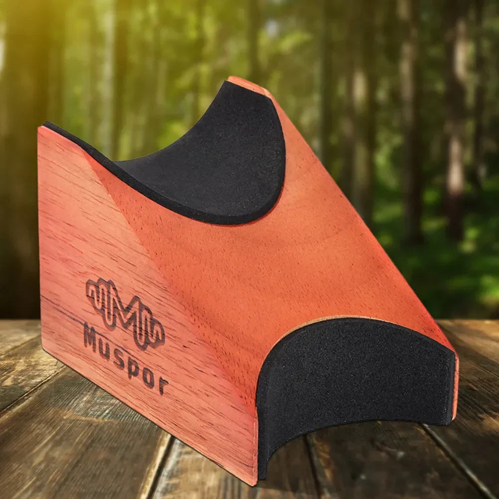 Orange wooden guitar neck rest bracket with black rubber padding and muspore branding for string instrument stand