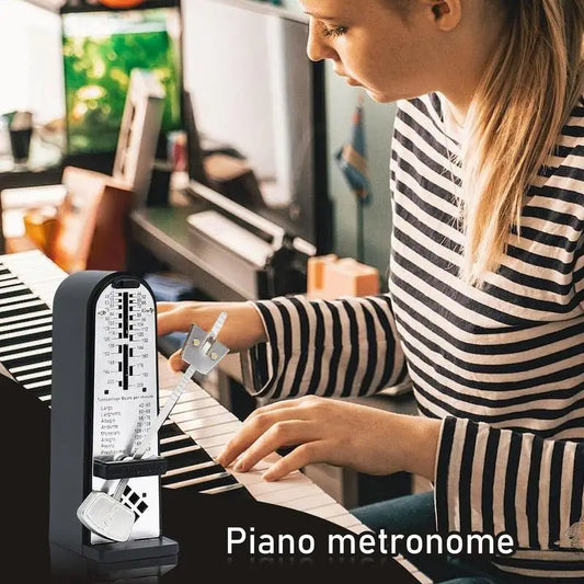 Black mechanical metronome with silver pendulum and adjustable tempo markings for piano metronome adjustable use