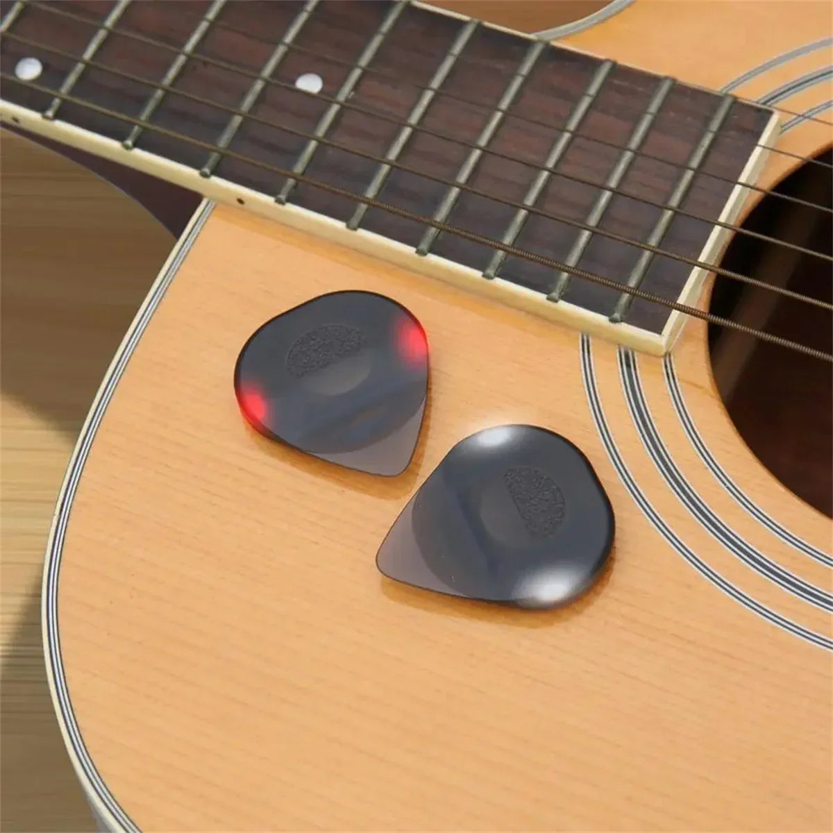 Two translucent black plastic guitar picks with a subtle red glow featuring high-sensitivity led light for bass electric guitarists instrument glowing plectrum