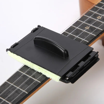 Black plastic guitar string cleaner with light green sponge pad and handle for easy grip as a clean fretboard cloth tool