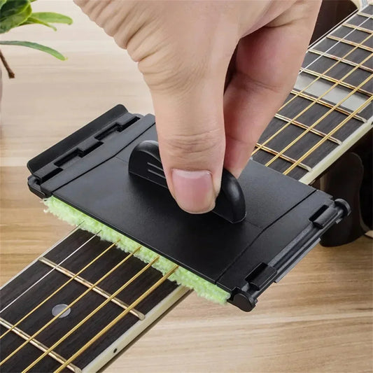 Black plastic guitar string cleaner with green microfiber clean fretboard cloth and finger grip handle for guitar maintenance