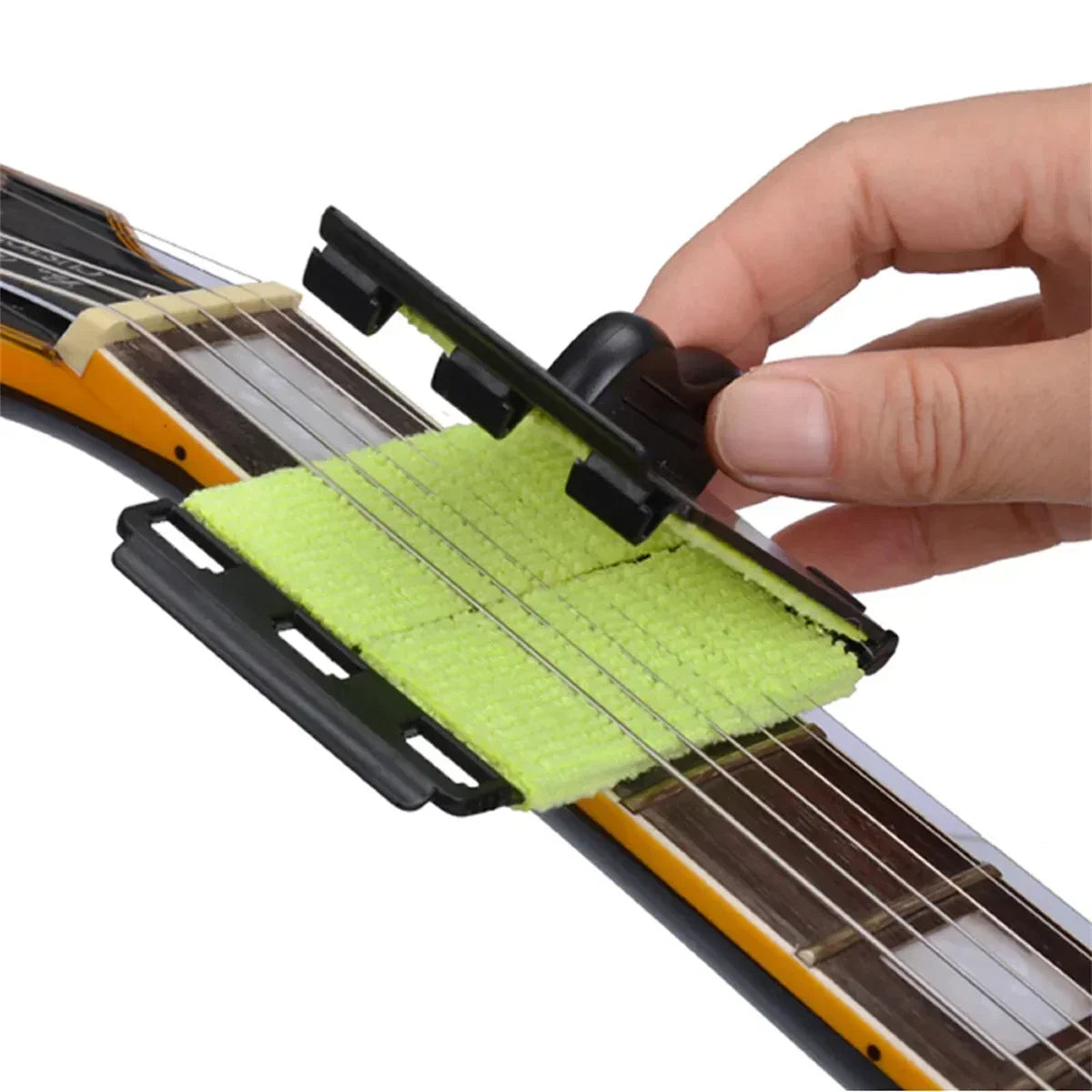 Black plastic-framed guitar string cleaner with bright green microfiber clean fretboard cloth tool for maintenance and care