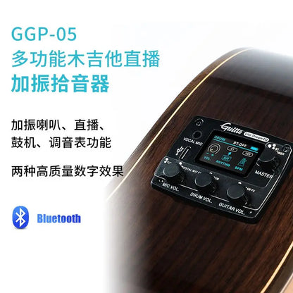 Black guitar vibration pickup system with digital display and control knobs mounted on acoustic classical folk guitar body