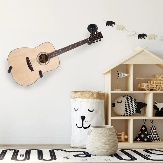 Light-colored acoustic guitar with natural wood finish mounted on a guitar wall mount for music shop exhibition