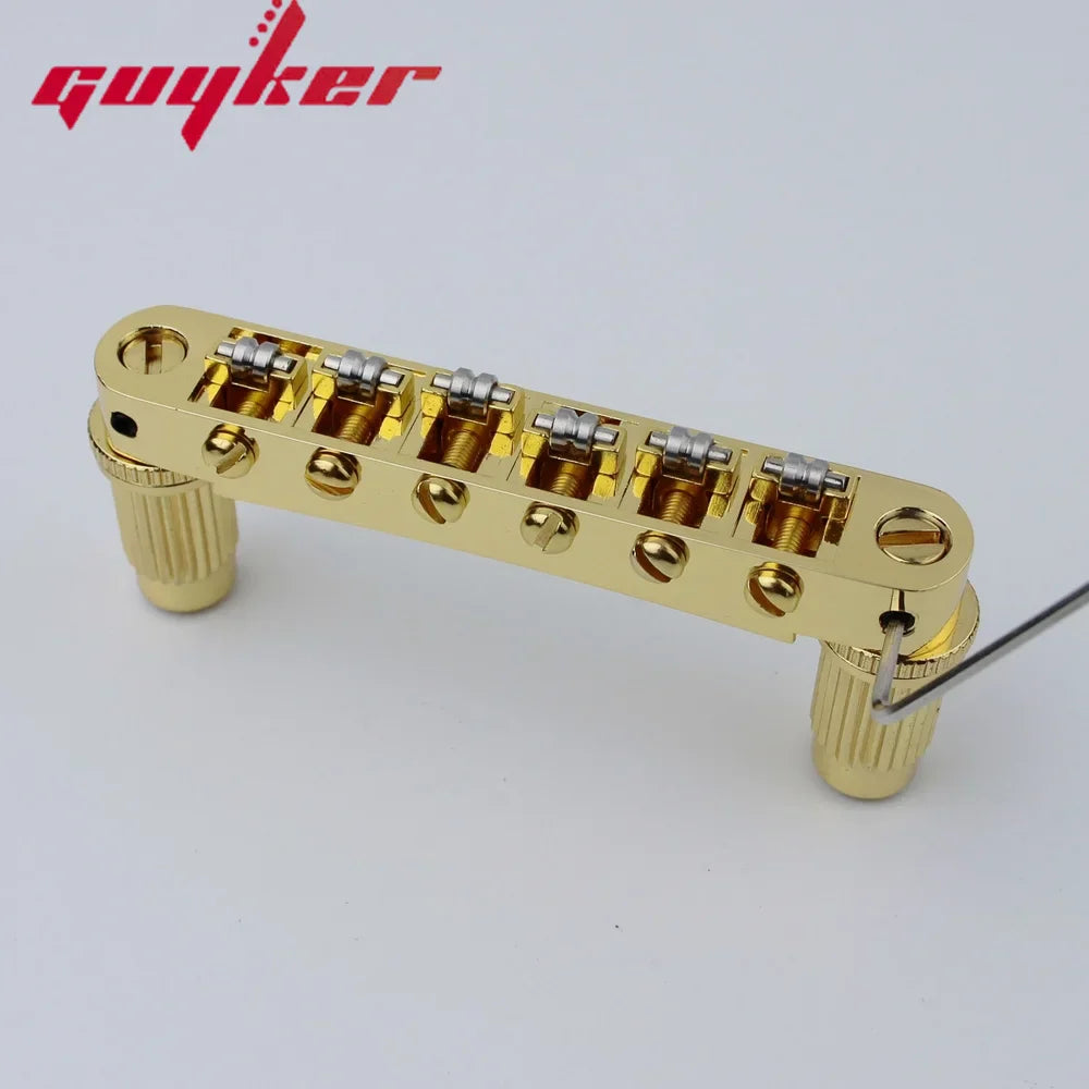 Gold-finished guyker tune-o-matic roller saddle guitar bridge with six silver tuning machines and textured knobs for lp sg guitars