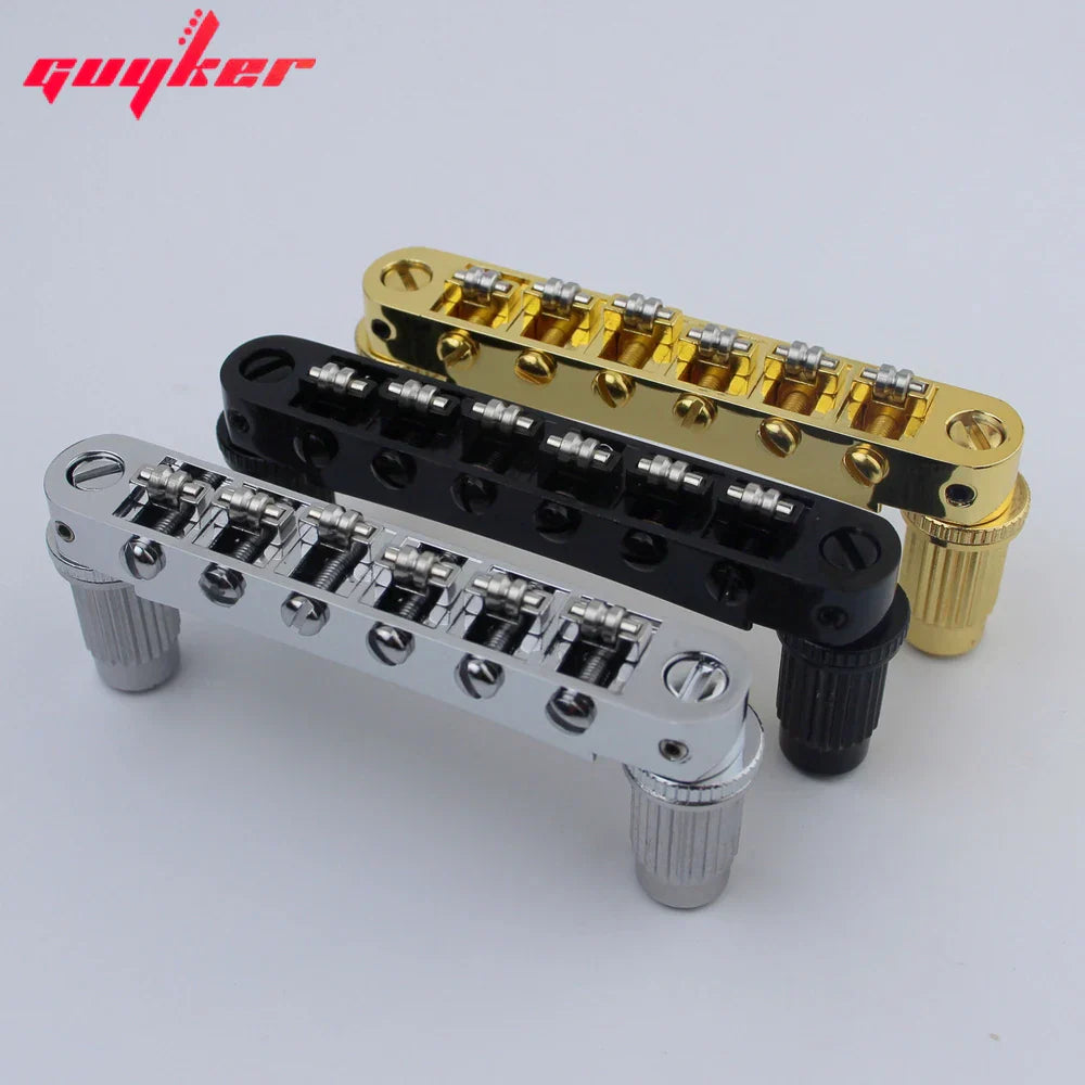 Three guyker tune-o-matic roller saddle guitar bridges with chrome finish and black or gold bodies for electric guitars