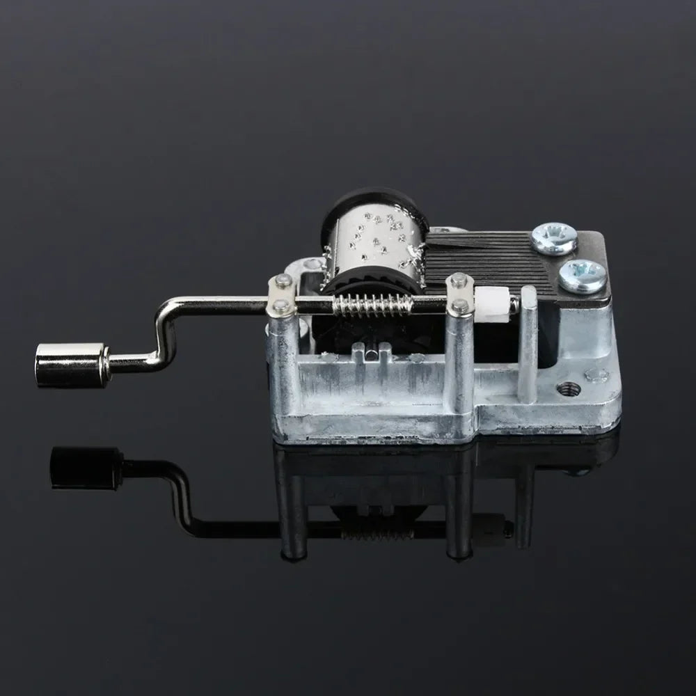 Silver-toned metal hand crank music box diy craft mechanism with visible internal gears and crank handle for box musical movement