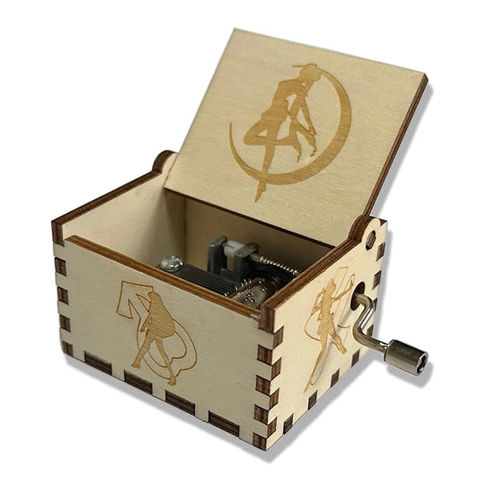 A light-colored wooden hand-cranked music box sailor with engraved Sailor Moon ornament designs for girls