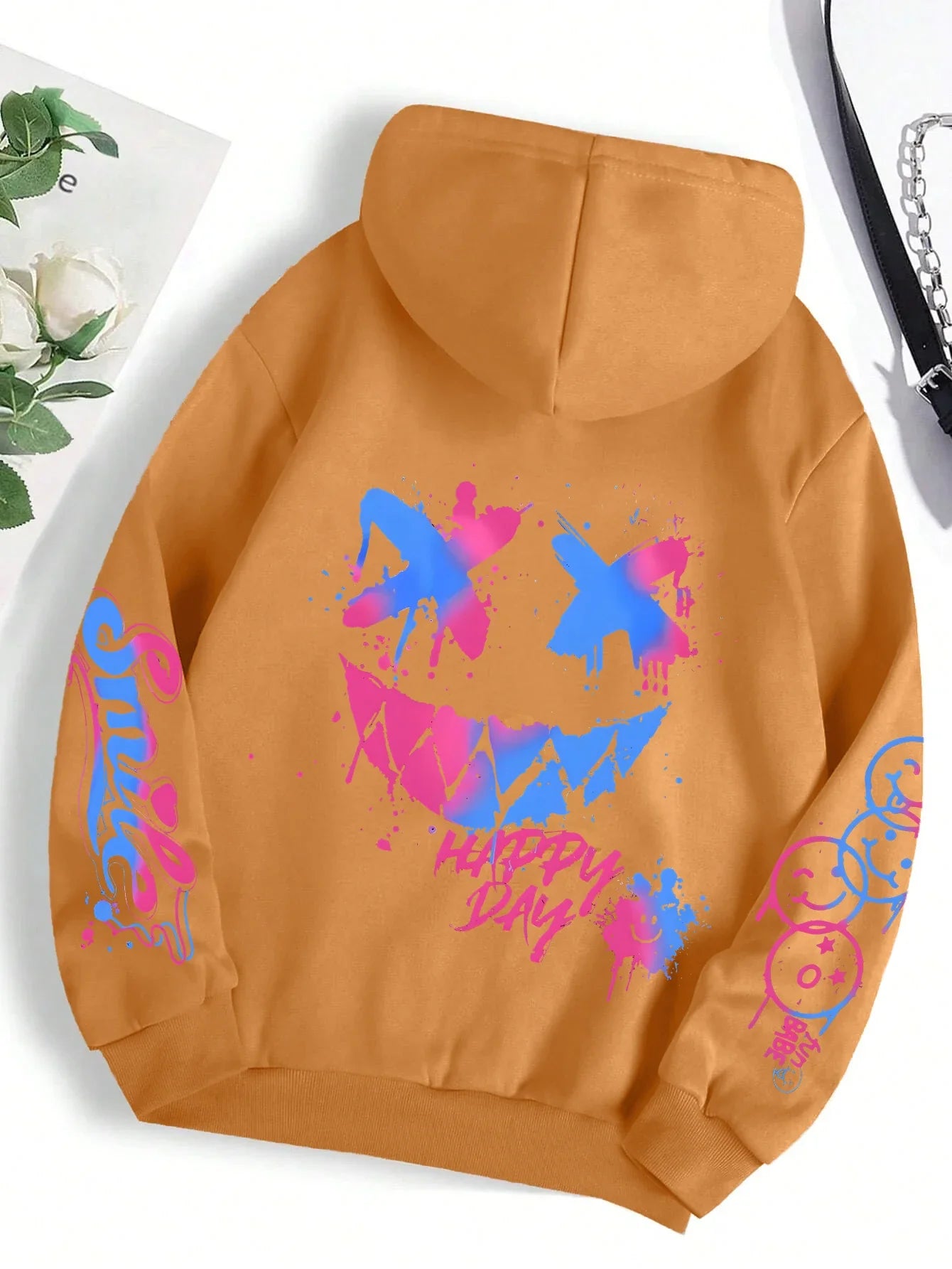A mustard-yellow happy day graffiti hoodie street hip featuring a vibrant blue and pink smiley face graphic and crewneck design