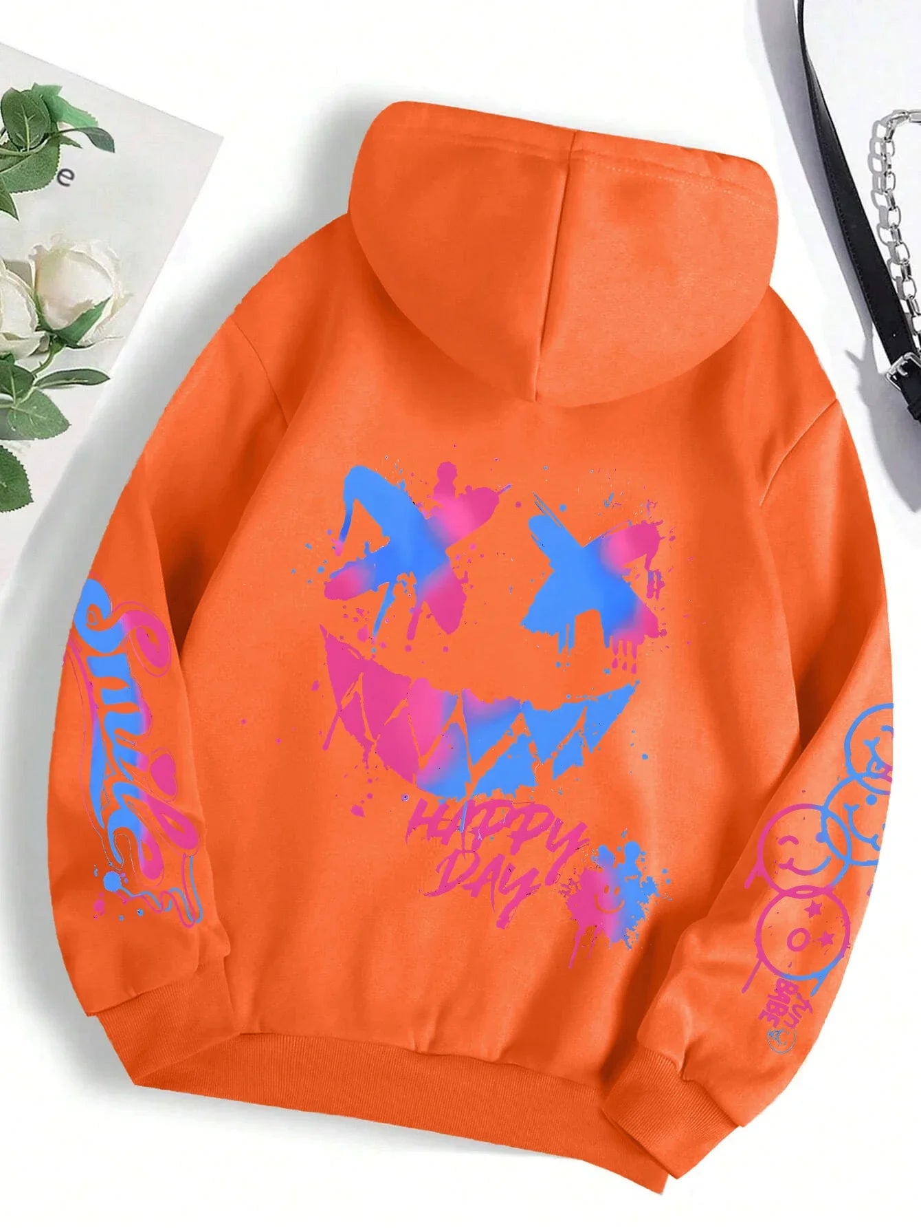 Vibrant orange happy day graffiti hoodie street hip featuring bold blue and pink graffiti smiley face and text sleeves