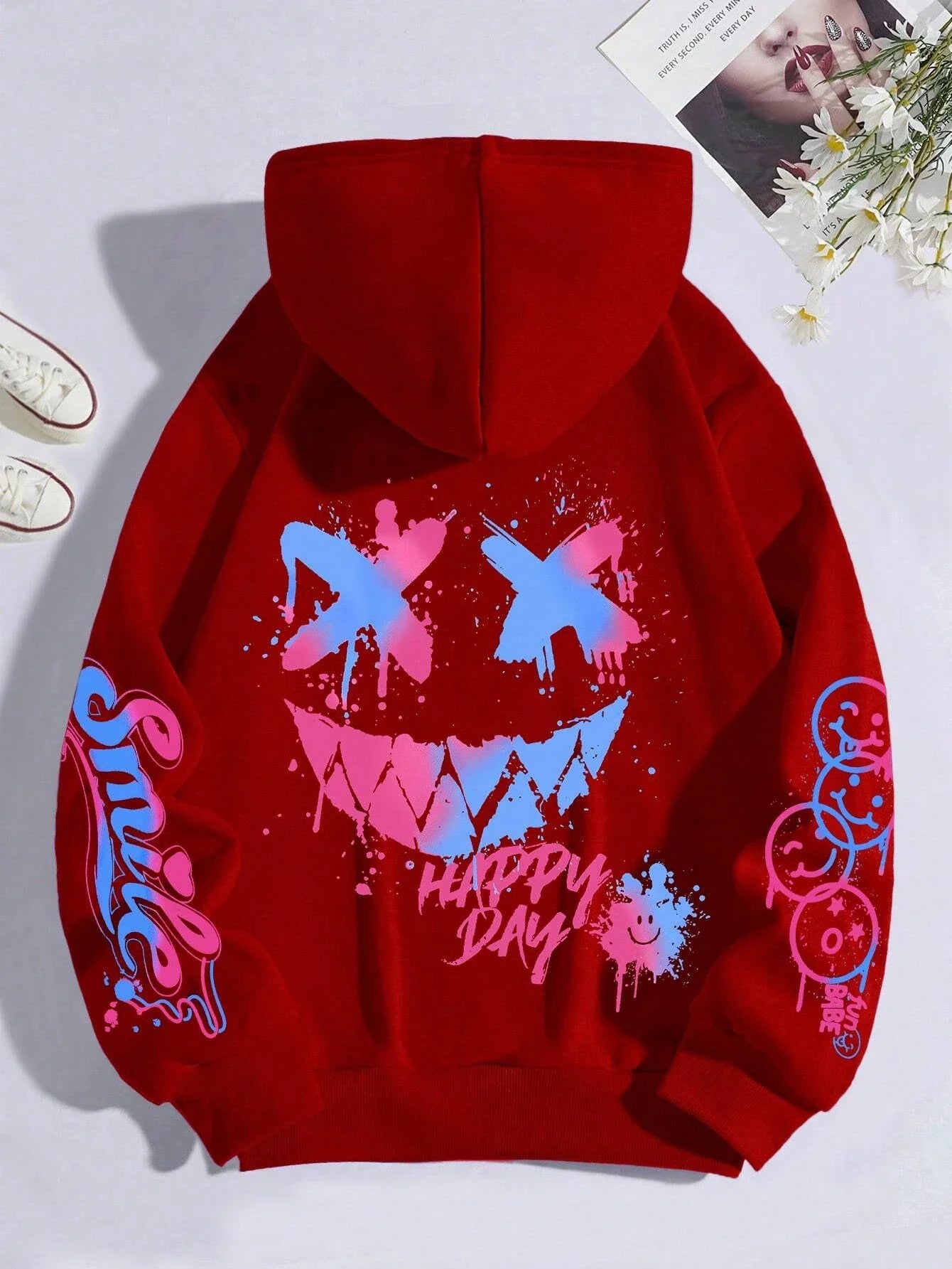 Red hoodie street hip with vibrant blue and pink happy day graffiti smiley face design on the back and crewneck style