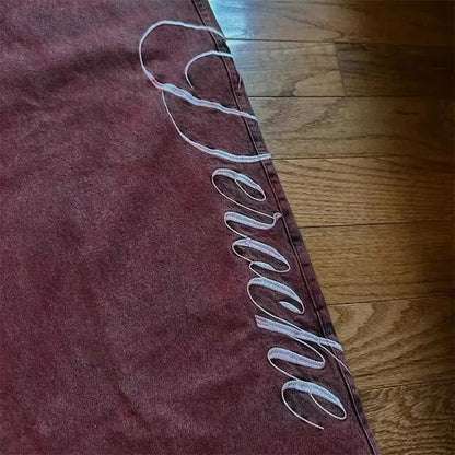 Maroon denim skirt with white cursive embroidery along side seam styled with belt jeans y2k street casual look