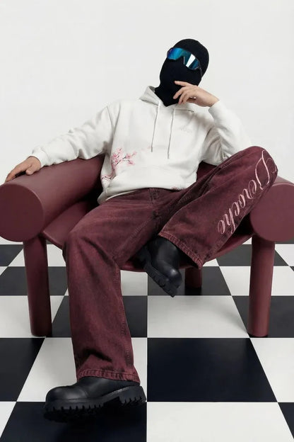 White hoodie with subtle pink cherry blossom embroidery paired with burgundy eyelet belt jeans y2k street casual style