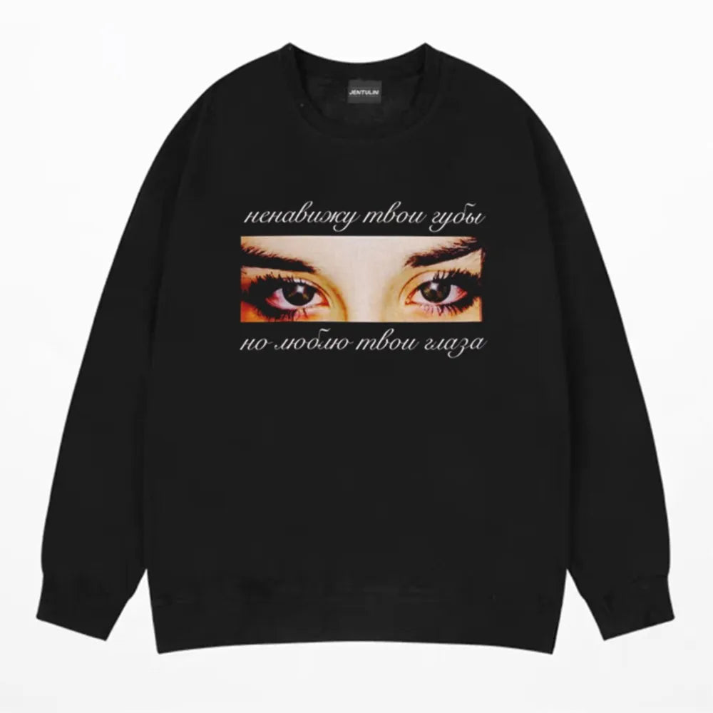 Black crewneck sweatshirt with intense eyes graphic and russian cursive text in harajuku oversized streetwear goth y2k winter style