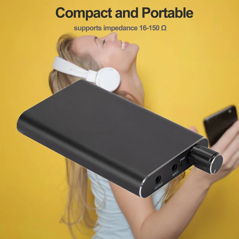 Black compact portable headphone amplifier with silver accents and rotary knob for jack aux portable audio use
