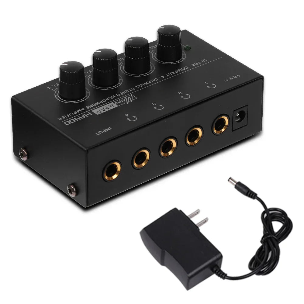 Black rectangular ultra-compact stereo headphone amplifier with 4 knobs and 35mm gold audio jacks and power adapter