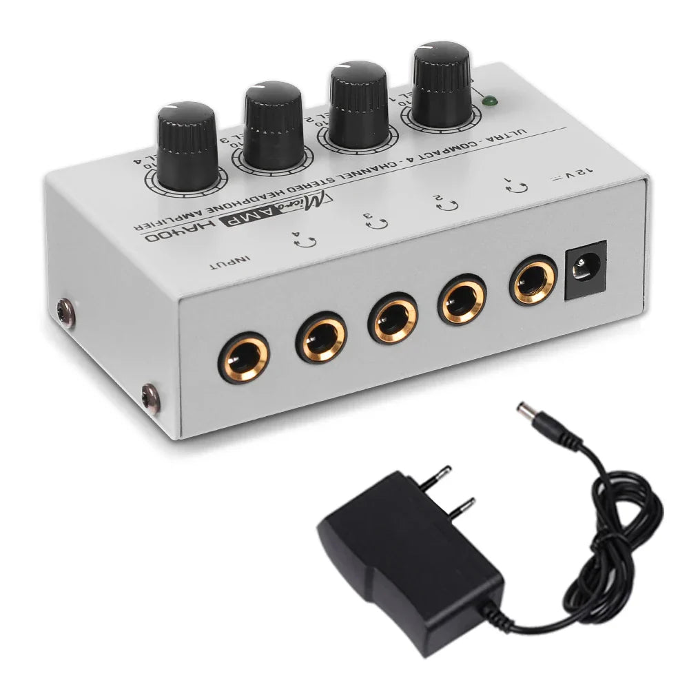 Silver ultra-compact stereo headphone amplifier with 35mm jack, black knobs, gold-plated jacks, and matching adapter
