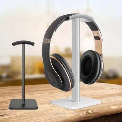 Silver and black Beats Studio3 headphones with gold accents on a silver aluminum alloy headphones stand universal for desktop gaming earphones