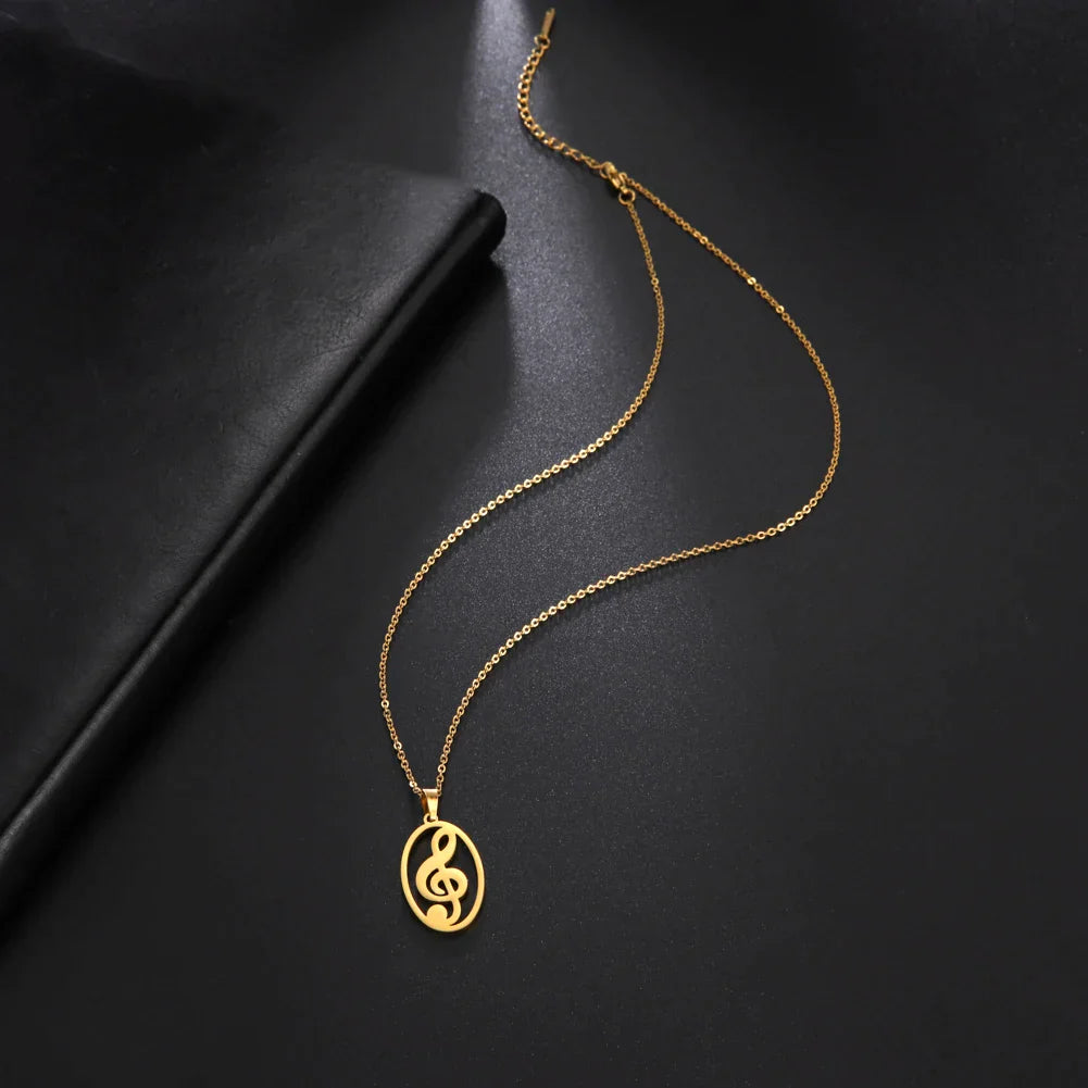 Gold-toned stainless steel note treble necklace with oval pendant and cut-out heart music note design ideal for gift