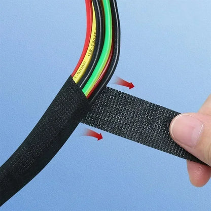 Black woven fabric cable tie with adhesive backing securing colorful wires for heat-resistant car electrical tape protection