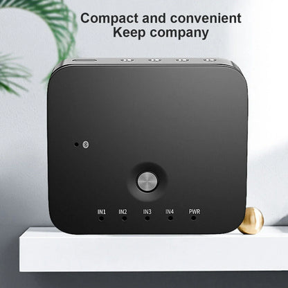 Black rectangular hifi 4 port aux audio switcher with silver button showing labeled input output ports for wireless music bluetooth audio receivers remote use