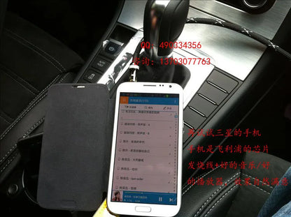 White samsung smartphone with black flip cover on car center console showing hifi excellent ami skoda music interface use