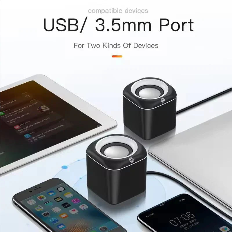 Black cube-shaped hifi mini desktop usb speakers with silver accents and circular drivers for laptop pc suround stereo subwoofer aux playback
