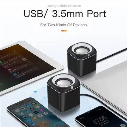 Black cube-shaped hifi mini desktop usb speakers with silver accents and circular drivers for laptop pc suround stereo subwoofer aux playback