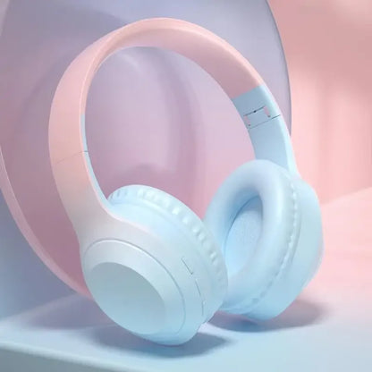 Pastel pink and light blue wireless over-ear headphones with soft padded earcups featuring noise cancelling gaming and stereoscopic surround sound wireless technology