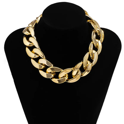 Gold-colored thick curb-link quality exaggerated acrylic ccb link choker necklace on black mannequin bust for statement hip hop look