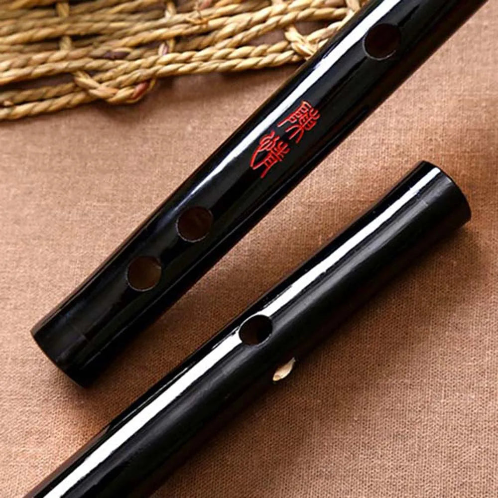 Black lacquered bamboo dizi flute with red chinese characters engraved for traditional musical instruments beginners