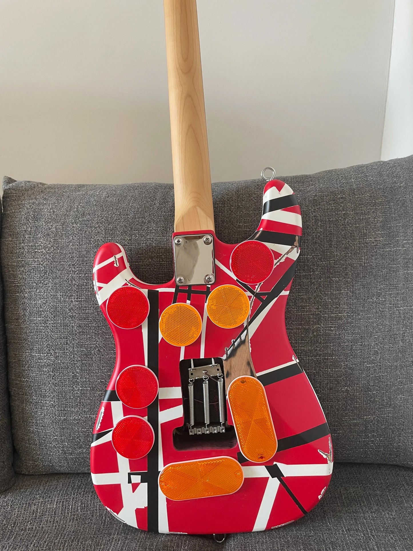 High quality red electric guitar with floyd rose tremolo bridge distressed and bold black white stripes on body