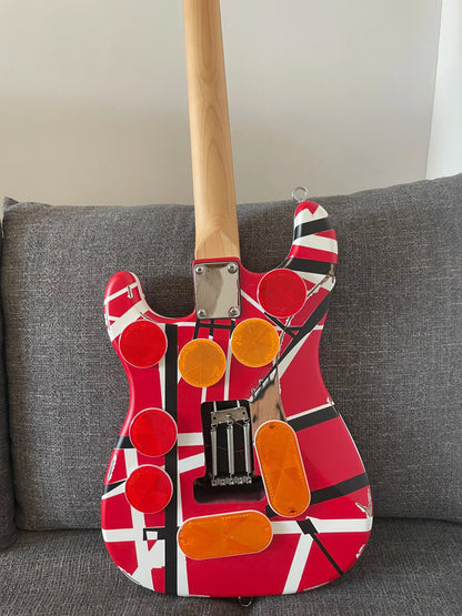 High quality red electric guitar with floyd rose tremolo bridge distressed and bold black white stripes on body