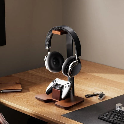 Black over-ear gaming headset with silver accents on a wooden headphone stand detachable creative headphone holder