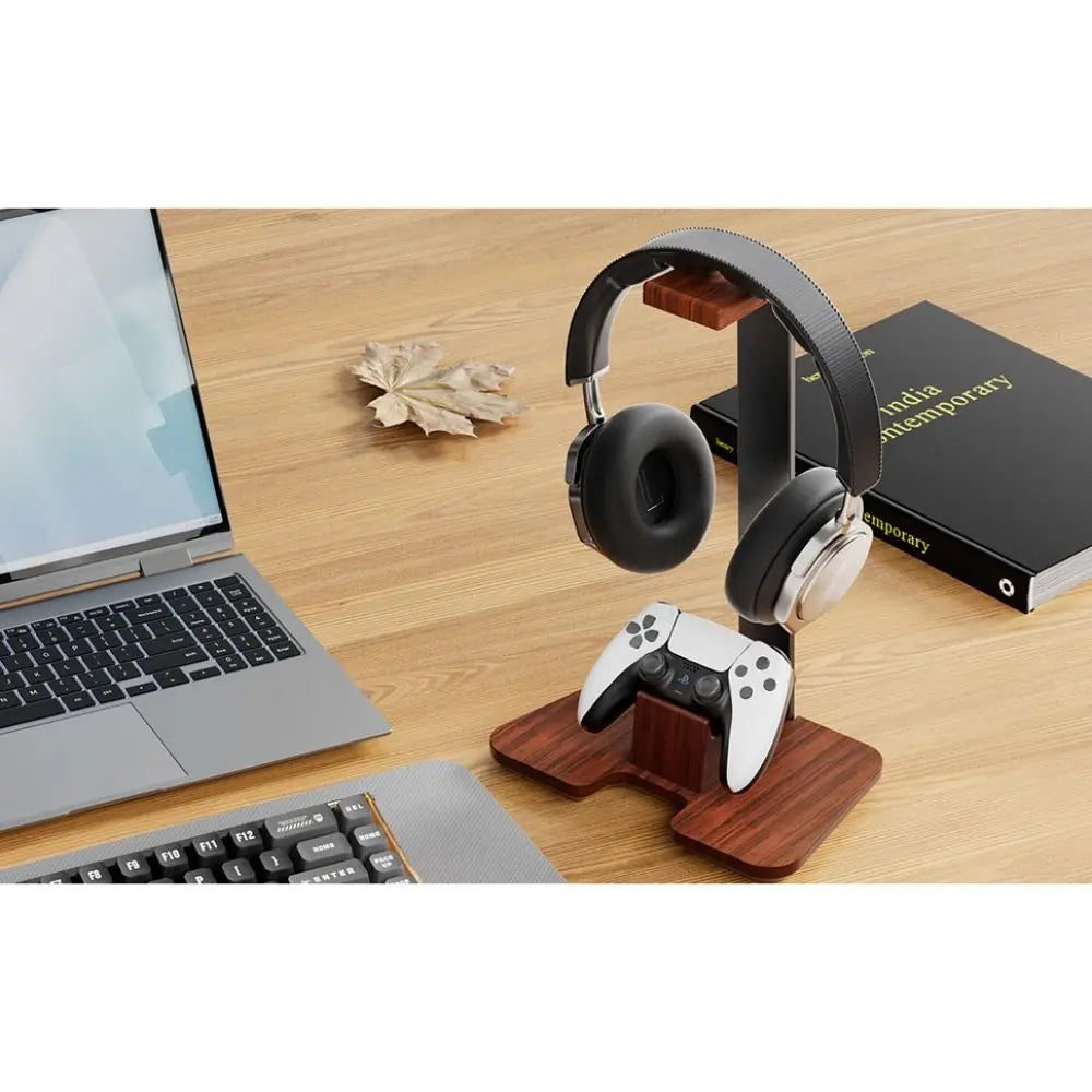 Wooden headphone stand detachable holding black and silver headphones with a white playstation 5 controller below