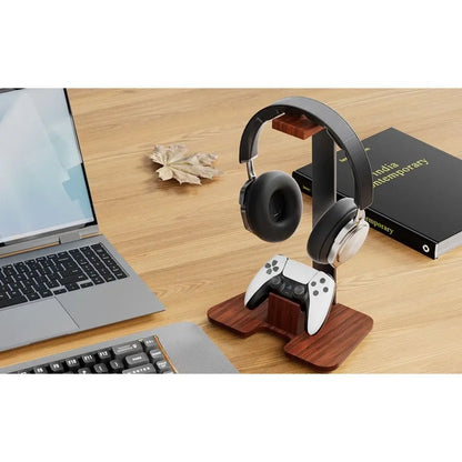 Wooden headphone stand detachable holding black and silver headphones with a white playstation 5 controller below