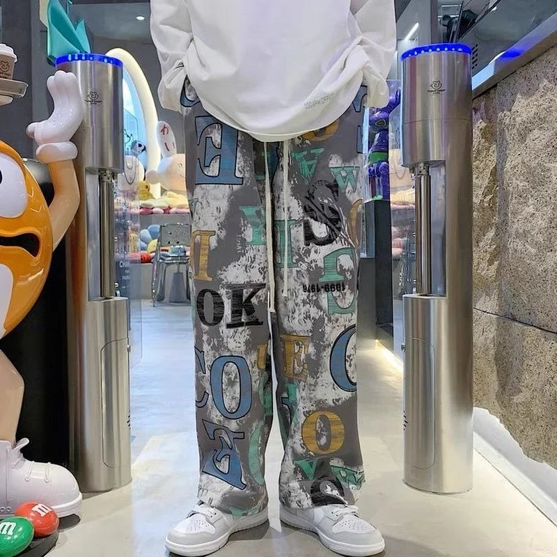 Gray high street graffiti trousers man american with graphic print and distressed fabric for casual hip-hop wear